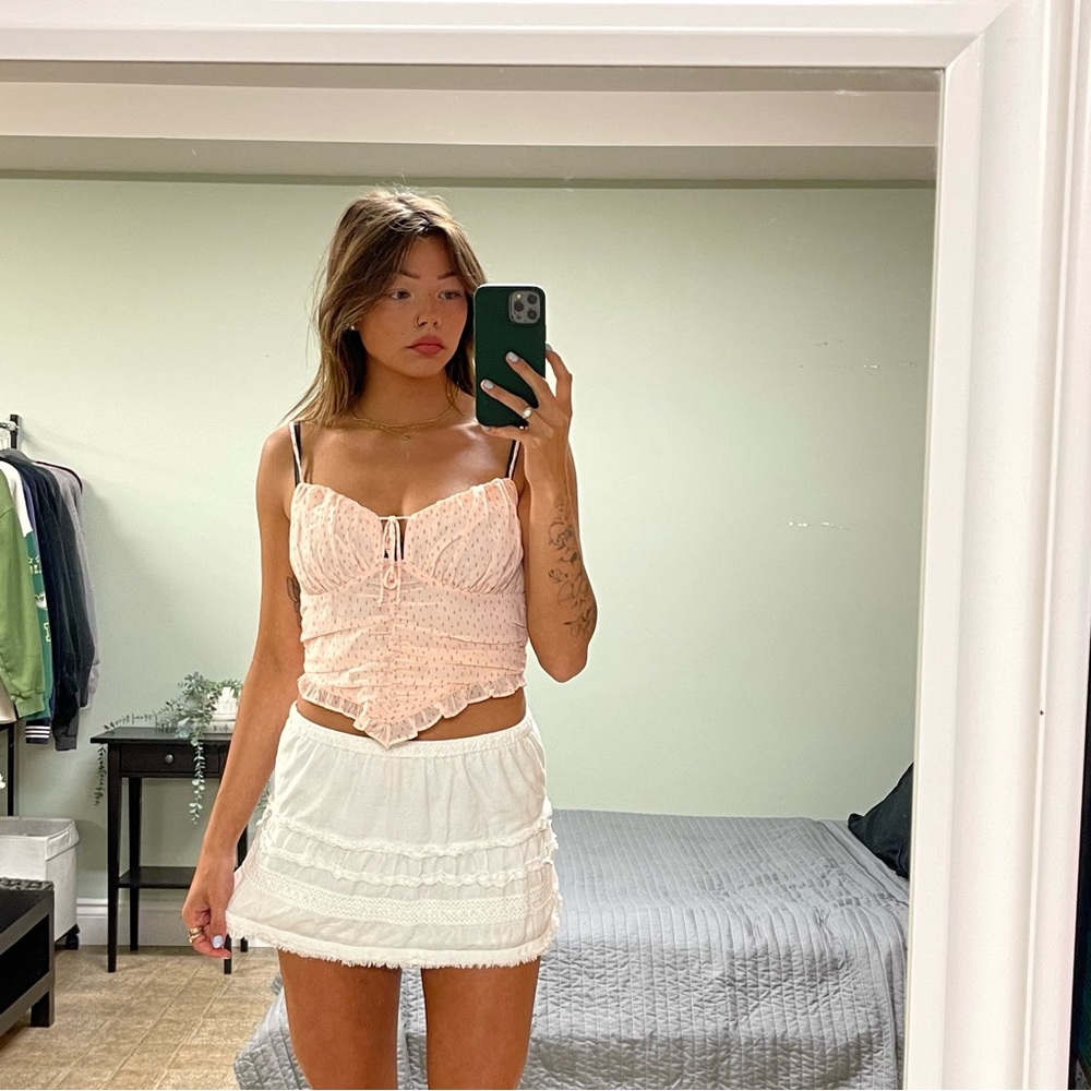 Light pink spotted tank top. Ruched mid section with adjustable straps and tie